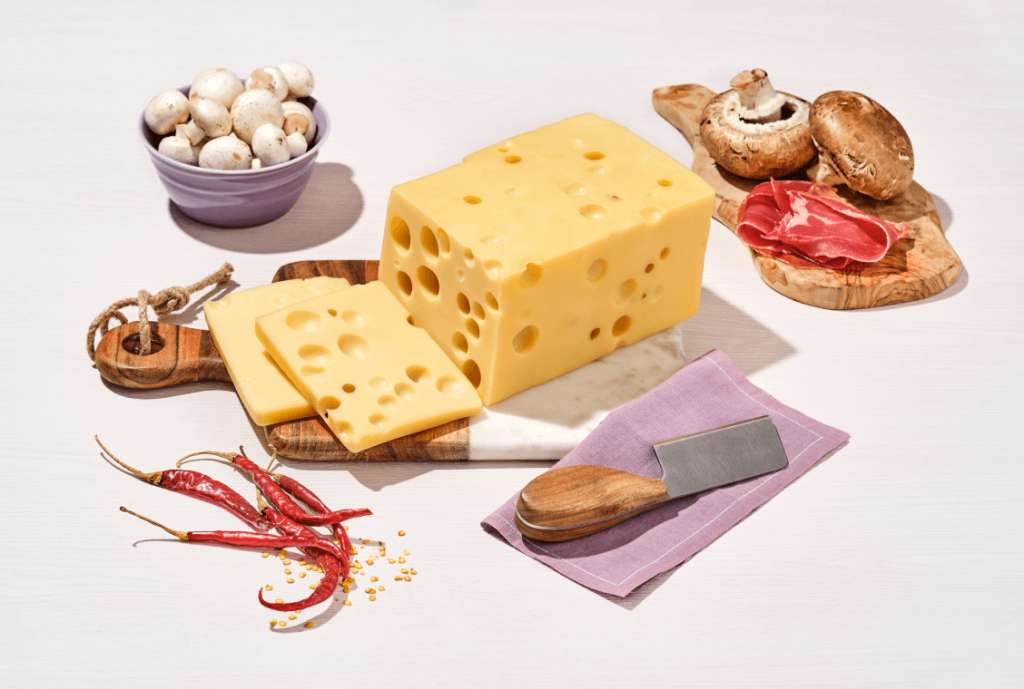 El queso Emmental, famoso por sus hoyitos (también llamados “ojos”), proviene de la región de Savoie, Francia, muy cerca de la frontera con Suiza.