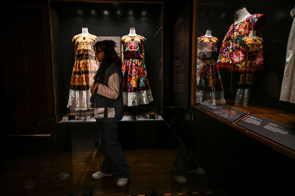 An employee of the "Casa Kahlo Museum" shows one of the exhibition rooms during a guided tour of the museum's facilities in the Coyoacan neighborhood of Mexico City, October 3, 2025.