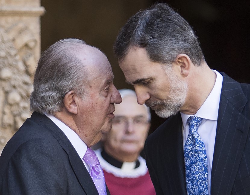 (FILES) In this file photo taken on April 01, 2018 King Felipe VI of Spain (R) listens to his father, former King Juan Carlos I, as they leave after attending the traditional Easter Sunday Mass of Resurrection in Palma de Mallorca on April 1, 2018. - The Spanish Royal House announced on August 2, 2020 that former king Juan Carlos will move out of Spain. The Spanish Supreme Court announced in June the opening of an investigation to establish whether former King Juan Carlos has criminal responsibility in an alleged corruption case when Saudi Arabia entrusted the construction of the Mecca TGV to a Spanish consortium. (Photo by JAIME REINA / AFP)