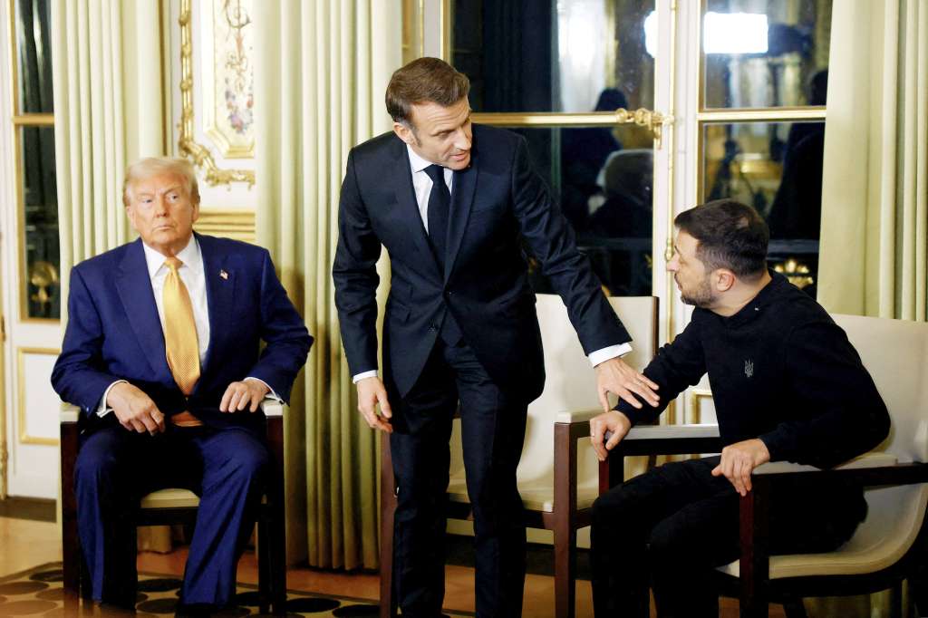 France's President Emmanuel Macron (C), US president-elect Donald Trump (L) and Ukraine's President Volodymyr Zelensky pose before a meeting at The Elysee Presidential Palace in Paris on December 7, 2024.