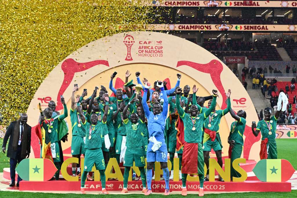 Senegal's forward #10 Sadio Mane holds up the trophy as he celebrates with his teammates after winning the Africa Cup of Nations (CAN) final football match between Senegal and Morocco at the Prince Moulay Abdellah Stadium in Rabat on January 18, 2026. (Photo by SEBASTIEN BOZON / AFP)