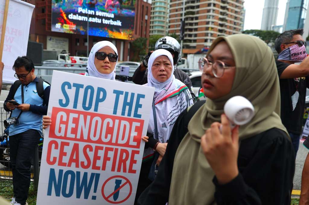 KUALA LUMPUR (Malaysia), 16/05/2025.- A protester holds a placard near the US embassy during the 'Nakba 77 Stop Genocide' gathering in solidarity with the Palestinian people, in Kuala Lumpur, Malaysia, 16 May 2025. Nakba Day (Day of the Catastrophe) is commemorated annually on 15 May to remember their displacement of Palestinians following the 1948 Israeli Declaration of Independence. (Protestas, Malasia) EFE/EPA/FAZRY ISMAIL