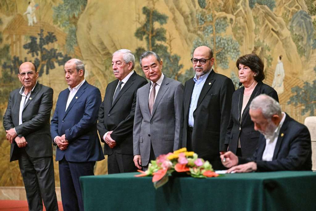 Beijing (China), 23/07/2024.- China's Foreign Minister Wang Yi (C) looks on during the signing of the 'Beijing declaration' at the Diaoyutai State Guesthouse in Beijing, China, 23 July 2024. China's Foreign Minister Wang Yi on 23 July hailed an agreement by 14 Palestinian groups to set up an 'interim national reconciliation government' to govern Gaza when the ongoing conflict is over. Palestinian groups including Hamas and Fatah met in Beijing this week in a renewed bid for reconciliation. EFE/EPA/PEDRO PARDO / POOL
