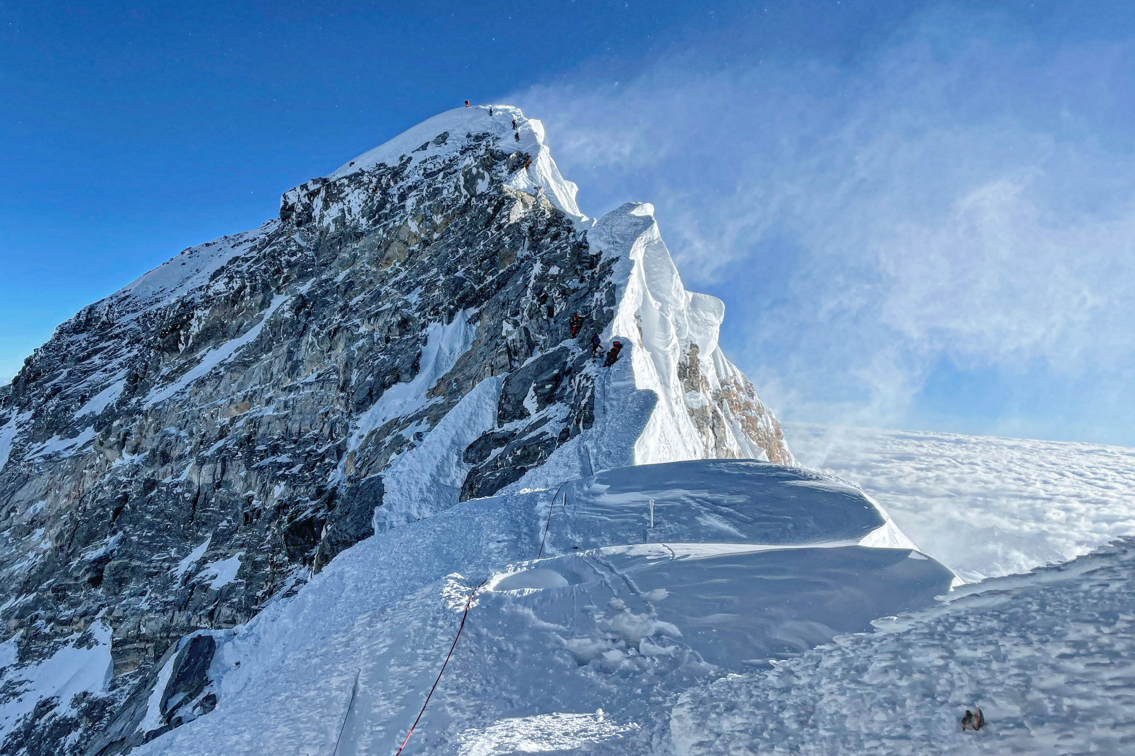 (FILES) This photograph taken on May 31, 2021 shows mountaineers climbing the Hillary Step during their ascend of the South face to summit Mount Everest (8,848.86-metre), in Nepal.