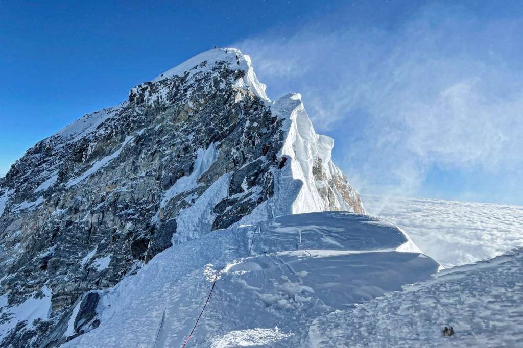 (FILES) This photograph taken on May 31, 2021 shows mountaineers climbing the Hillary Step during their ascend of the South face to summit Mount Everest (8,848.86-metre), in Nepal.