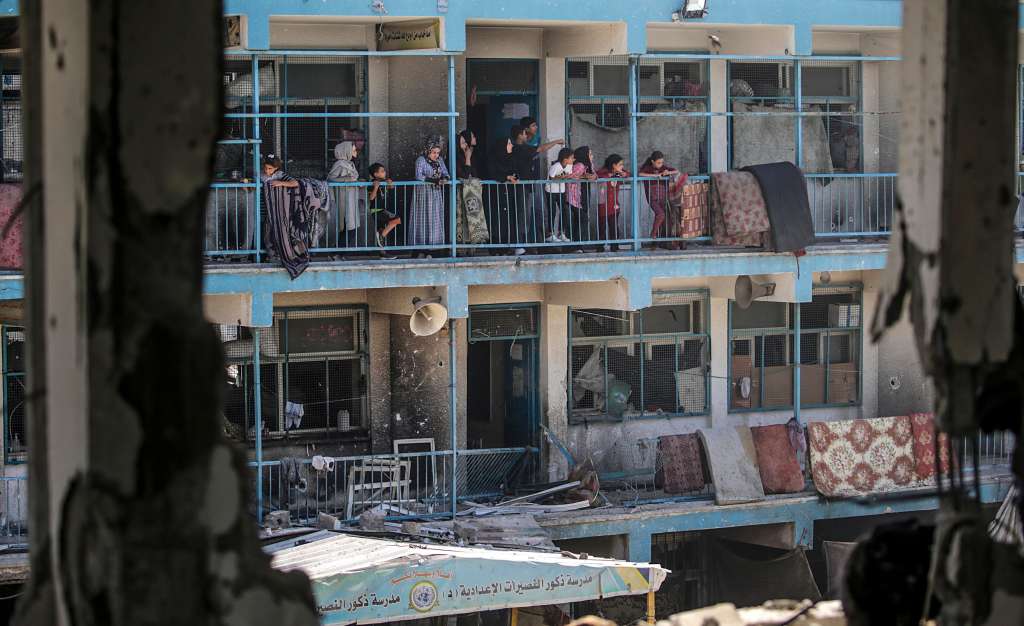 Al Nusairat Refugee Camp (-), 06/06/2024.- Internally displaced Palestinians look out from the balcony of a damaged UNRWA school building following an Israeli airstrike in Al Nusairat refugee camp in the central Gaza Strip on, 06 June 2024.According to the Palestinian News Agency Wafa, at least 32 people were killed and dozens others were injured on early 06 June following an Israeli strike on a UNRWA school sheltering displaced Palestinians, located in the Nuseirat refugee camp in the central Gaza strip. The Israeli army said that it had "conducted a precise strike on a Hamas compound", whose members were " embedded in the UNRWA school". More than 36,000 Palestinians and over 1,400 Israelis have been killed, according to the Palestinian Health Ministry and the Israel Defense Forces (IDF), since Hamas militants launched an attack against Israel from the Gaza Strip on 07 October 2023, and the Israeli operations in Gaza and the West Bank which followed it. EFE/EPA/MOHAMMED SABER