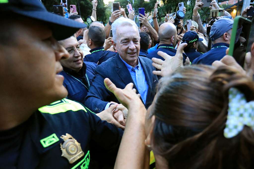 (FILES) Former Colombian President Alvaro Uribe Velez (C) greets a supporter after being released from house arrest in Sabaneta, Antioquia department, Colombia on August 20, 2025.