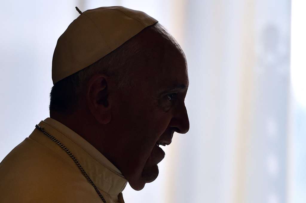 (FILES) Pope Francis is silhouetted against window light during a private audience with Malta's President, Marie-Louise Coleiro Preca at the Vatican on September 29, 2014.
