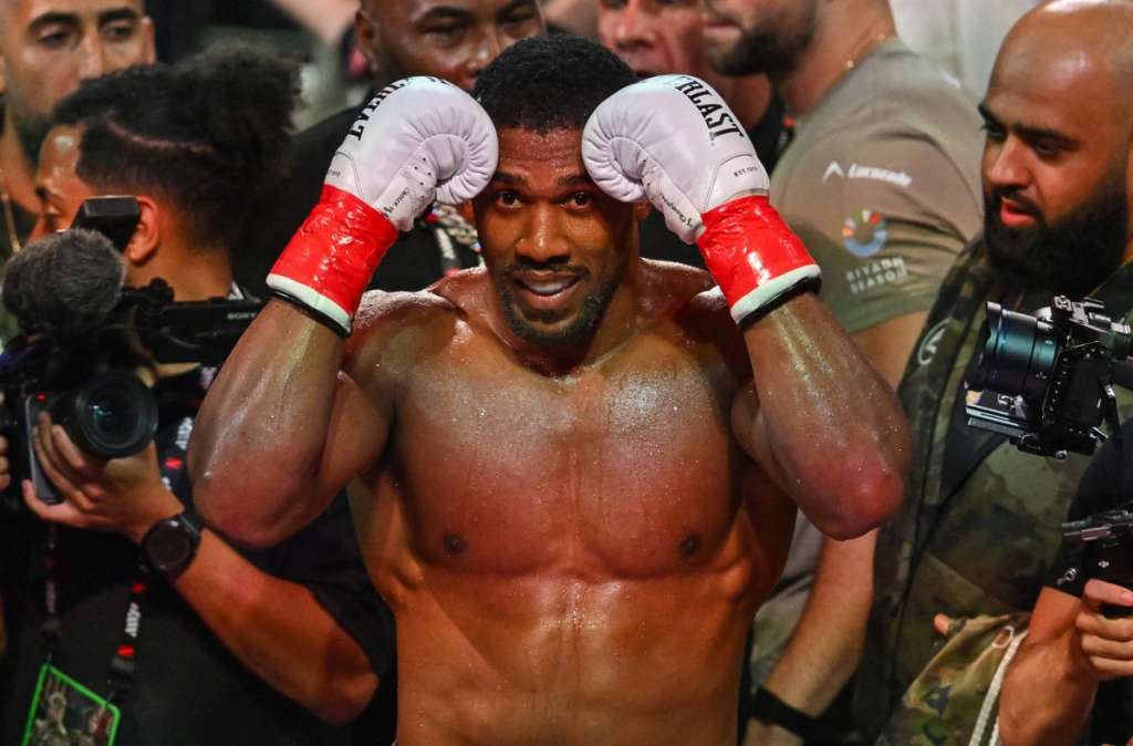 (FILES) British boxer Anthony Joshua celebrates after defeating US boxer and influencer Jake Paul (off frame) in a non-title heavyweight bout at the Kaseya Center in Miami, Florida, on December 19, 2025.