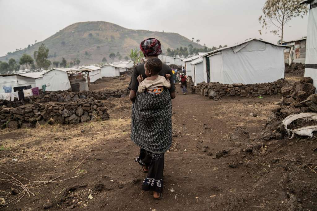 Mudja (Democratic Republic Of Congo), 20/08/2024.- Tuliza Bisere carries her daughter Ishara who was cured of mpox but still shows scars of the disease in the camp for internal displaced persons in Mudja, Democratic Republic of Congo, 20 August 2024. Democratic Republic of Congo'Äôs Health Minister Samuel-Boger Kamba said the death toll due to the mpox outbreak now stands at 'a little more than 570 deaths.' The World Health Organization has declared the rise in mpox cases in the Democratic Republic of the Congo and neighboring countries a public health emergency, with over 27,000 cases and more than 1,100 deaths reported since January 2023. Symptoms include fever, body aches, and rashes, and while there is no specific treatment for mpox, supportive care can aid recovery. The virus spreads through close contact with infected individuals and can persist on contaminated surfaces. EFE/EPA/MOISE KASEREKA