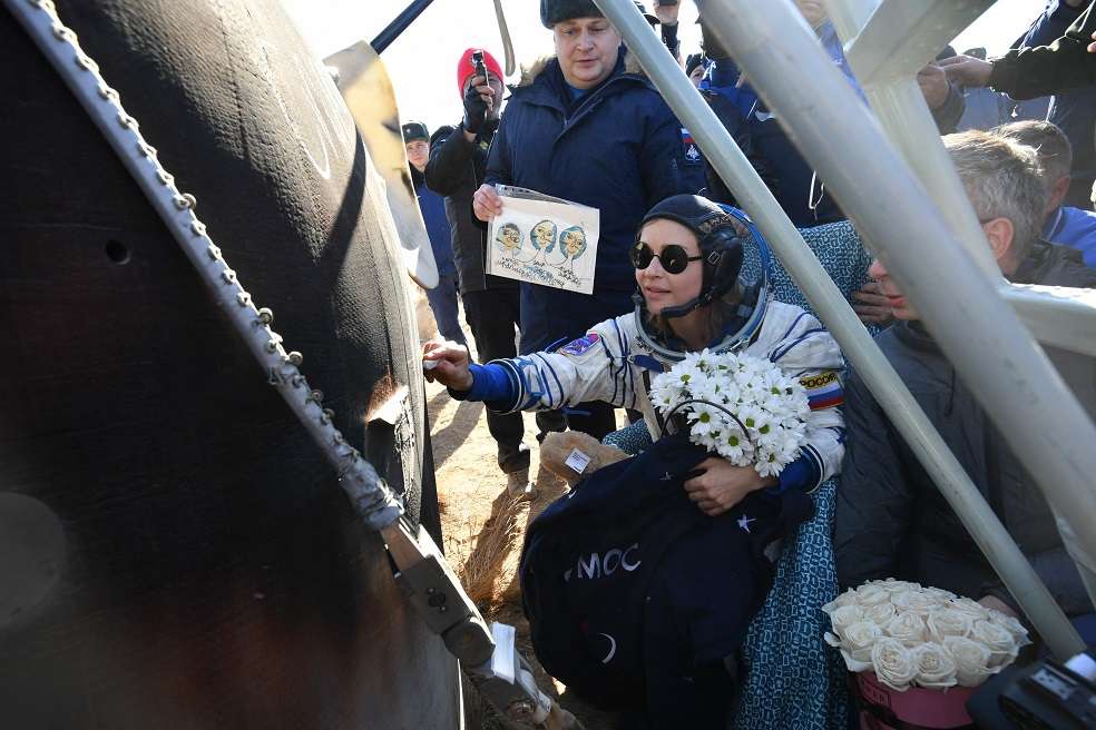 This handout photograph taken and released on October 17, 2021, by the Russian Space Agency Roscosmos, shows crew member, actress, Yulia Peresild, signs the side of the capsule after the landing of the Russian Soyuz MS-18 space capsule in a remote area southeast of Zhezkazgan in the Karaganda region of Kazakhstan, on October 17, 2021. The Russian actress and film director returned to Earth after spending 12 days on the International Space Station (ISS) shooting scenes for the first movie in orbit. - RESTRICTED TO EDITORIAL USE - MANDATORY CREDIT "AFP PHOTO / Russian space agency Roscosmos / HO " - NO MARKETING - NO ADVERTISING CAMPAIGNS - DISTRIBUTED AS A SERVICE TO CLIENTS
(Photo by Handout / RUSSIAN SPACE AGENCY ROSCOSMOS / AFP) / RESTRICTED TO EDITORIAL USE - MANDATORY CREDIT "AFP PHOTO / Russian space agency Roscosmos / HO " - NO MARKETING - NO ADVERTISING CAMPAIGNS - DISTRIBUTED AS A SERVICE TO CLIENTS