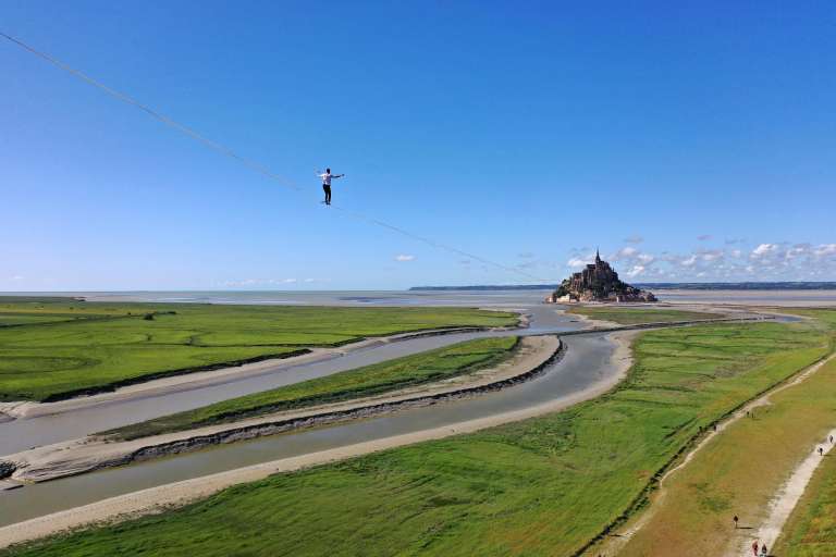 El equilibrista francés Nathan Paulin camina sobre una cuerda floja en la bahía de Le Mont Saint-Michel, en el noroeste de Francia, durante su intento de récord mundial de distancia