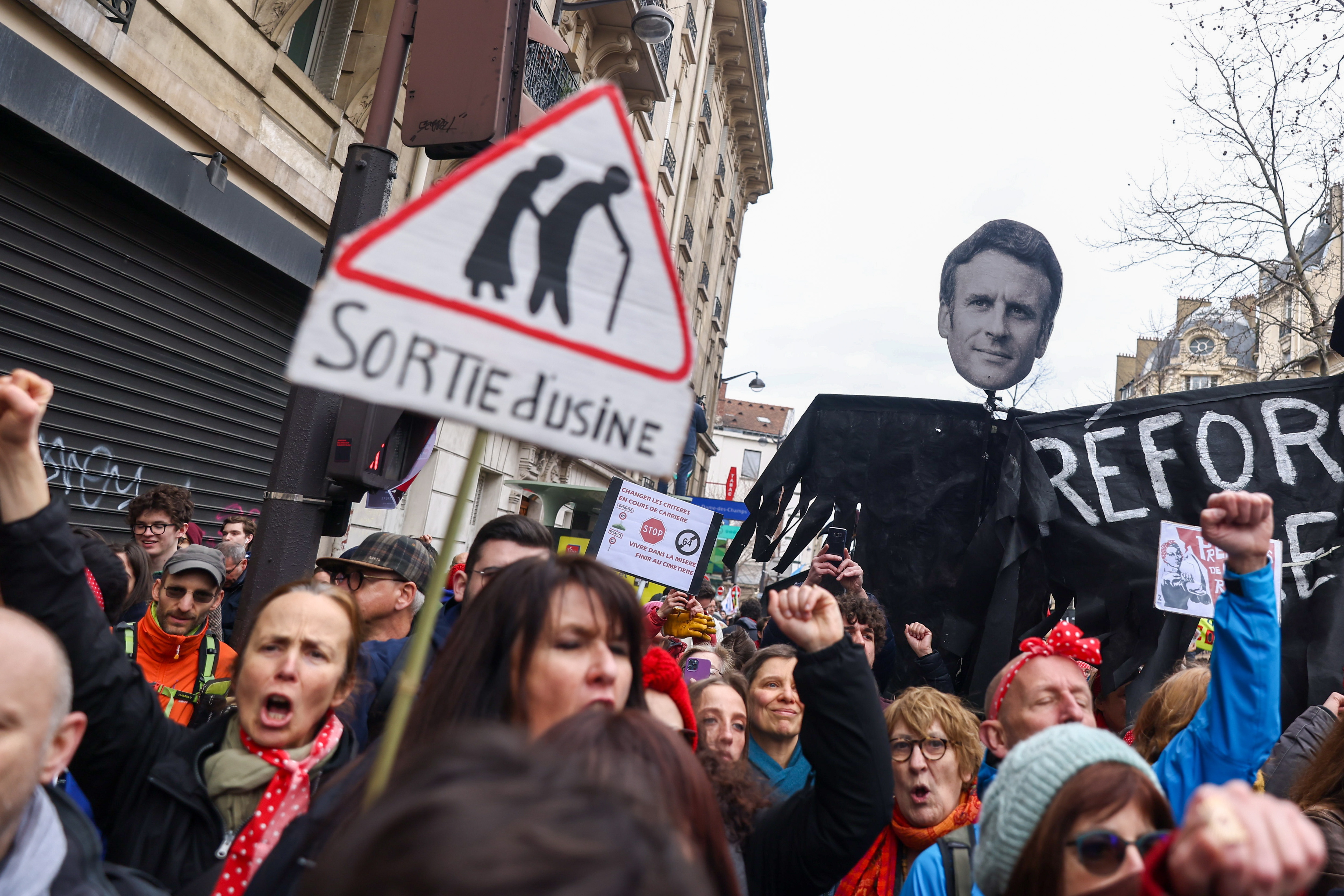 Paris (France), 07/03/2023.- Protesters hold a banner showing French President Macron's face, during a protest against the French government's planned reform of the pension system, in Paris, France, 07 March 2023. The French government plans to delay the minimum retirement age from 62 to 64, until 2030. (Protestas, Francia) EFE/EPA/MOHAMMED BADRA