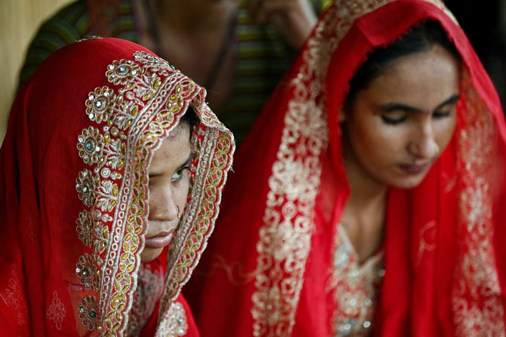 TOPSHOT - In this photograph taken on August 3, 2024 Shamila (L) and Salma Zameer, monsoon brides who were married underage look on at Khan Muhammad Mallah village, Dadu district in Sindh province.