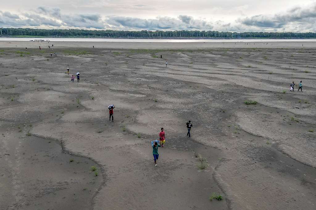 (FILES) Aerial view of Yagua Indigenous people carrying water and other goods due to the low level of the Amazon river at Isla de los Micos, Amazonas department, Colombia, on October 4, 2024.