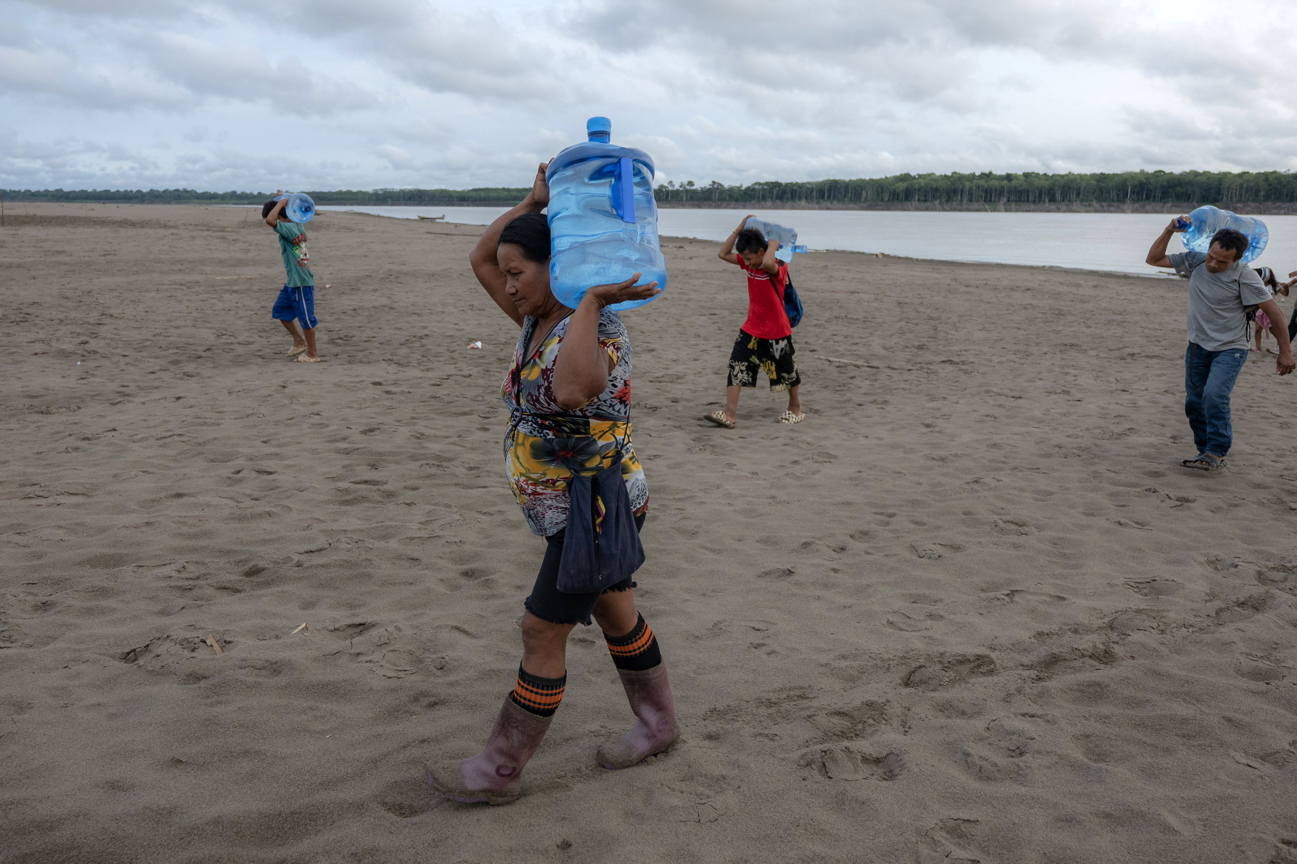 (FILES) Yagua Indigenous people carry water due to the low level of the Amazon river at Isla de los Micos, Amazonas department, Colombia, on October 4, 2024.