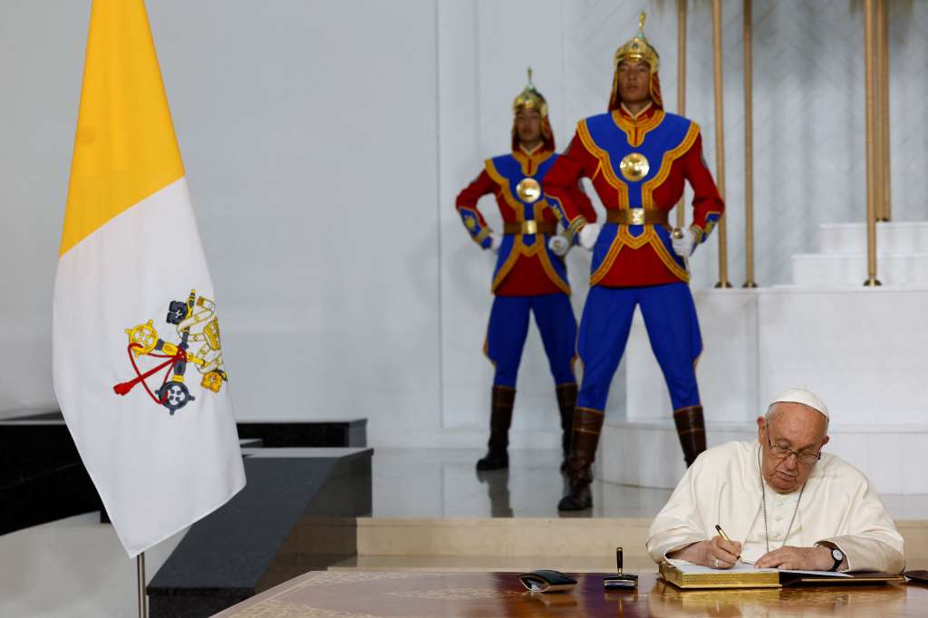 (FILES) Pope Francis signs the honour book as he meets with Mongolia's President Ukhnaagiin Khurelsukh during a courtesy visit at the State Palace in Ulaanbaatar on September 2, 2023.