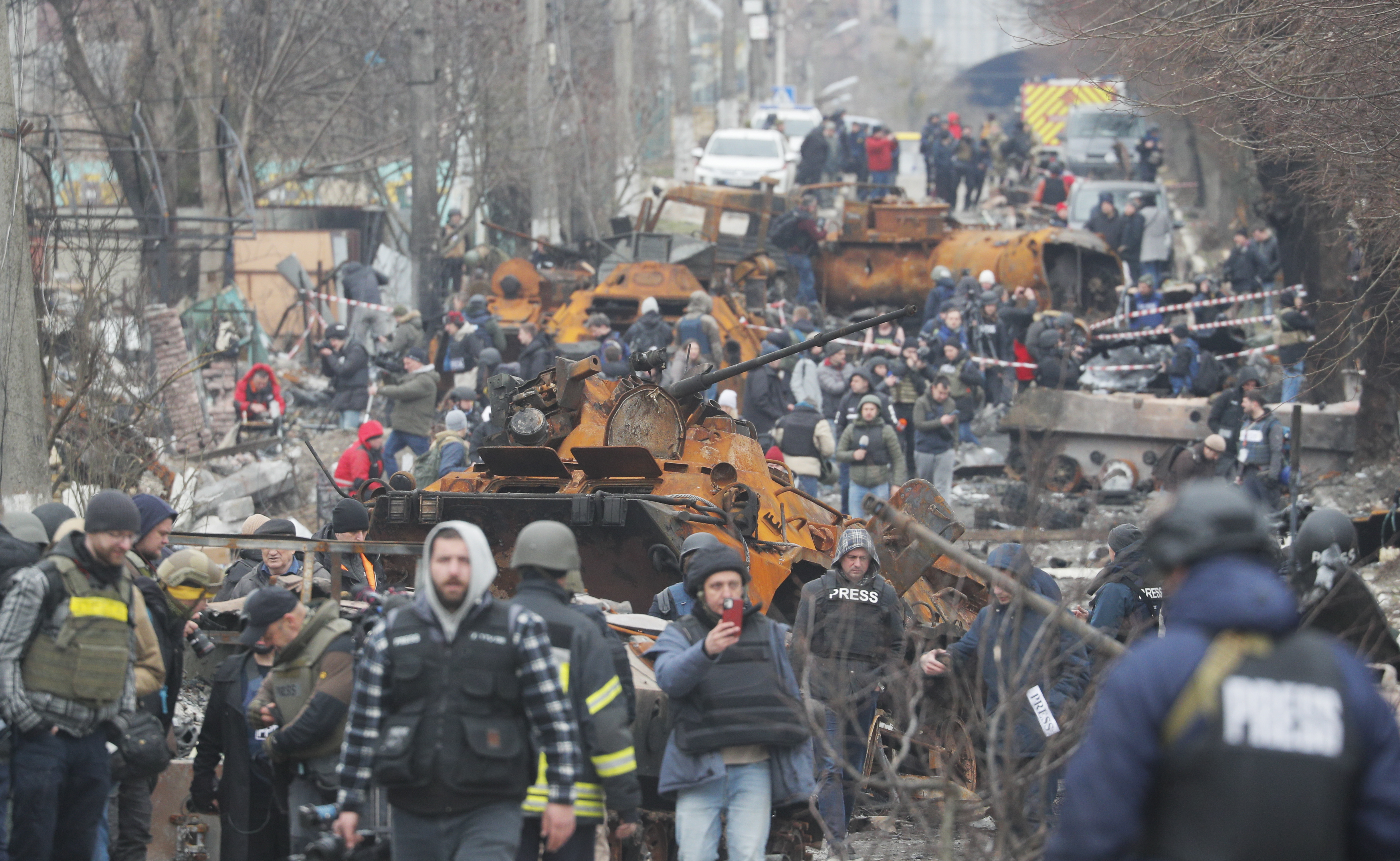 Bucha (Ukraine), 05/04/2022.- A picture taken during a visit to Bucha organized by Kyiv authorities shows journalists walking on a street with destroyed Russian military machinery in the recaptured by the Ukrainian army Bucha city near Kyiv, Ukraine, 05 April 2022. Russian troops entered Ukraine on 24 February resulting in fighting and destruction in the country, and triggering a series of severe economic sanctions on Russia by Western countries. (Rusia, Ucrania) EFE/EPA/SERGEY DOLZHENKO