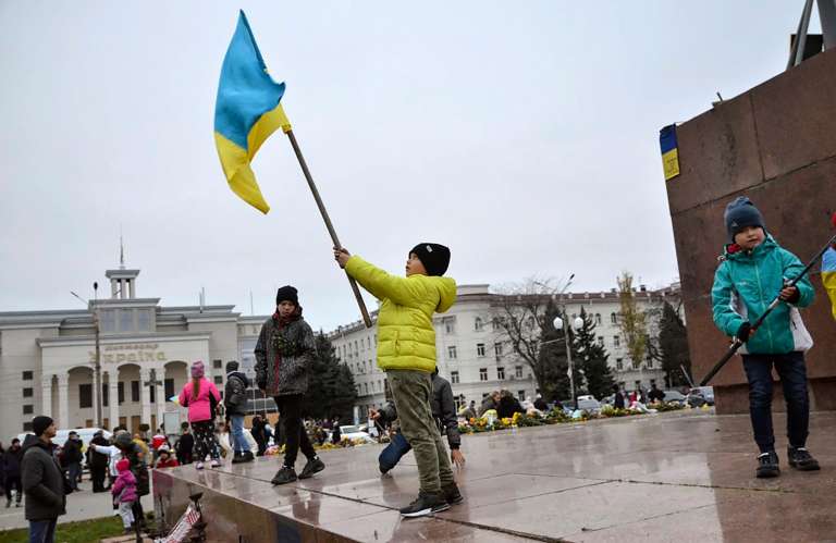 Kherson (Ukraine), 13/11/2022.- Children wave Ukrainian flags at the main square in the recently recaptured city of Kherson, Ukraine, 13 November 2022. Ukrainian troops arrived in Kherson on 11 November following the Russian troops' withdrawal from the city. Russian troops entered Ukraine on 24 February 2022 starting a conflict that has provoked destruction and a humanitarian crisis. (Rusia, Ucrania) EFE/EPA/IVAN ANTYPENKO
