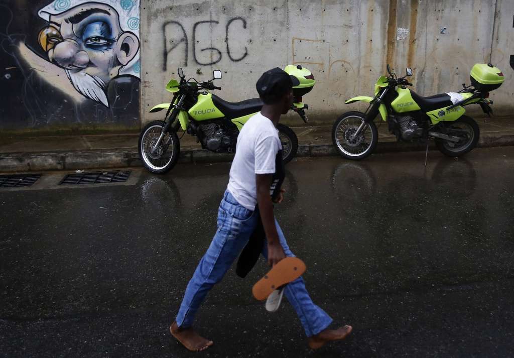 MED104 - MEDELLÍN (COLOMBIA), 06/05/2022.- Un niño camina frente a motos de la Policía Nacional de Colombia durante un patrullaje hoy en el barrio La Sierra en Medellín (Colombia) para garantizar la seguridad en este sector debido al "Paro Armado". Al menos 100 vehículos, entre camiones, autobuses y motocicletas, han resultado "afectados" por el "paro armado" ordenado el jueves por el Clan del Golfo en represalia por la extradición a EE.UU. de su máximo jefe, Dairo Antonio Úsuga, alias "Otoniel", acciones que también ha causado zozobra entre la población. EFE/Luis Eduardo Noriega A.