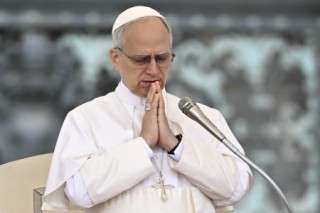 Pope Leo XIV prays at the end of his first weekly general audience at St Peter's Square in The Vatican on May 21, 2025. (Photo by Filippo MONTEFORTE / AFP)