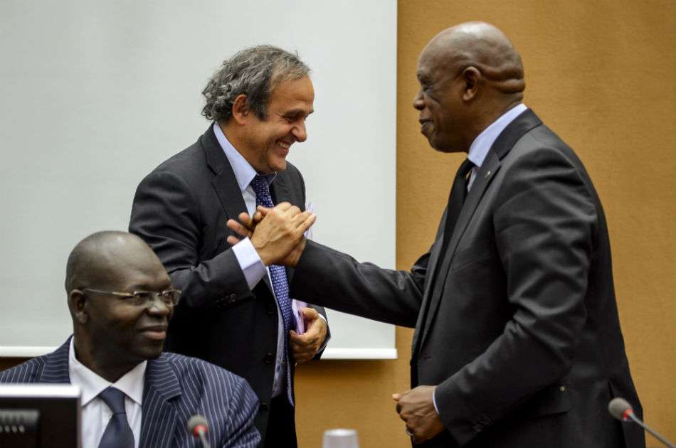Michel Platini saluda al exministro sudafricano Tokyo Sexwale, durante una reunión del grupo de trabajo sobre el racismo en las oficinas de las Naciones Unidas en Ginebra / AFP