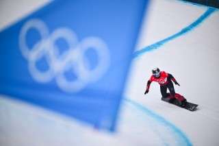 (FILES) Switzerland's Sophie Hediger competes in the snowboard women's cross seeding run during the Beijing 2022 Winter Olympic Games at the Genting Snow Park P & X Stadium in Zhangjiakou on February 9, 2022.