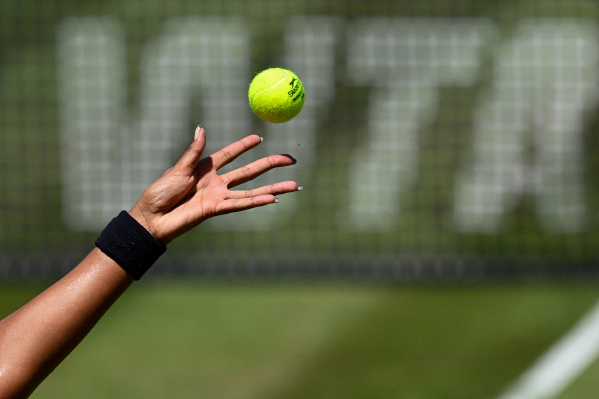 The hand of Japan's Naomi Osaka is pictured as she serves the ball while the WTA logo is seen in the background, during the women's singles quarter-final match of the WTA 500 Bad Homburg Open tennis tournament in Bad Homburg, western Germany on June 25, 2026. (Photo by Kirill KUDRYAVTSEV / AFP)