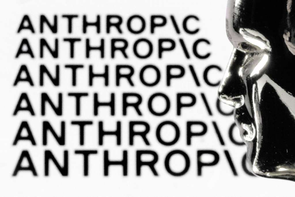 (FILES) This illustration photograph shows a figurine in front of the logo of the US artificial intelligence safety and research company Anthropic during a photo session in Paris on February 13, 2026.