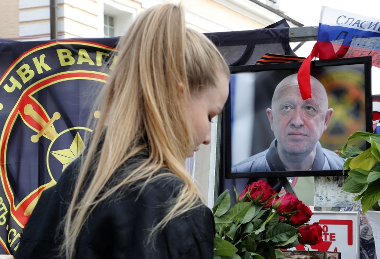 Moscow (Russian Federation), 28/08/2023.- A woman pays tribute in front of a portrait of Wagner Group chief Yevgeny Prigozhin at an informal memorial in Moscow, Russia, 28 August 2023. An investigation was launched into the crash of an aircraft in the Tver region in Russia on 23 August 2023, the Russian Federal Air Transport Agency said in a statement. Among the passengers was Wagner chief Yevgeny Prigozhin, the agency reported. According to the results of genetic testing on the 10 bodies recovered at the crash site, Russian authorities on August 27 confirmed the death of Yevgeny Prigozhin. (Rusia, Ucrania, Moscú) EFE/EPA/MAXIM SHIPENKOV