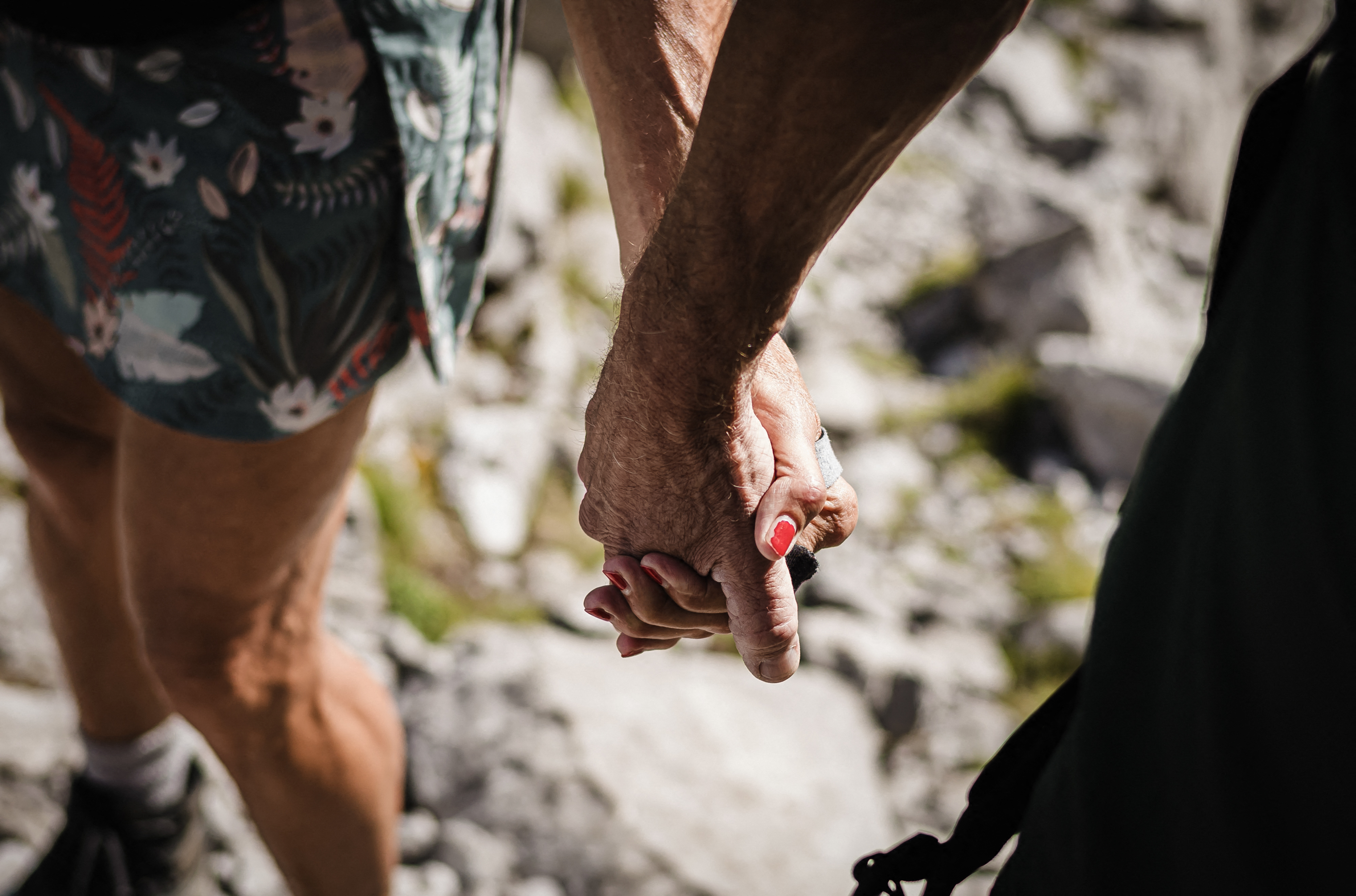 Patrick and Cathy, both 58 years old, walk hand in hand to the Wandflue peak, Bernese Alps, above Jaun of the Canton of Fribourg, on August 3, 2025.