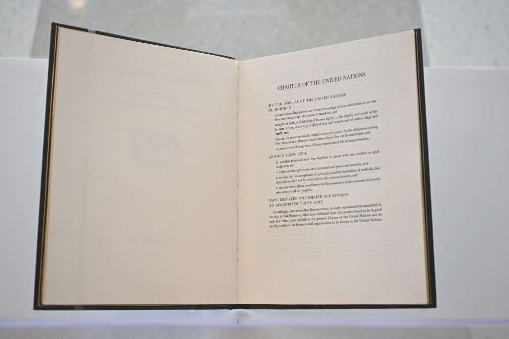 The UN Charter is displayed at an exhibition preview ahead of the 80th anniversary of its signing at the United Nations Headquarters on June 20, 2025 in New York. (Photo by ANGELA WEISS / AFP)