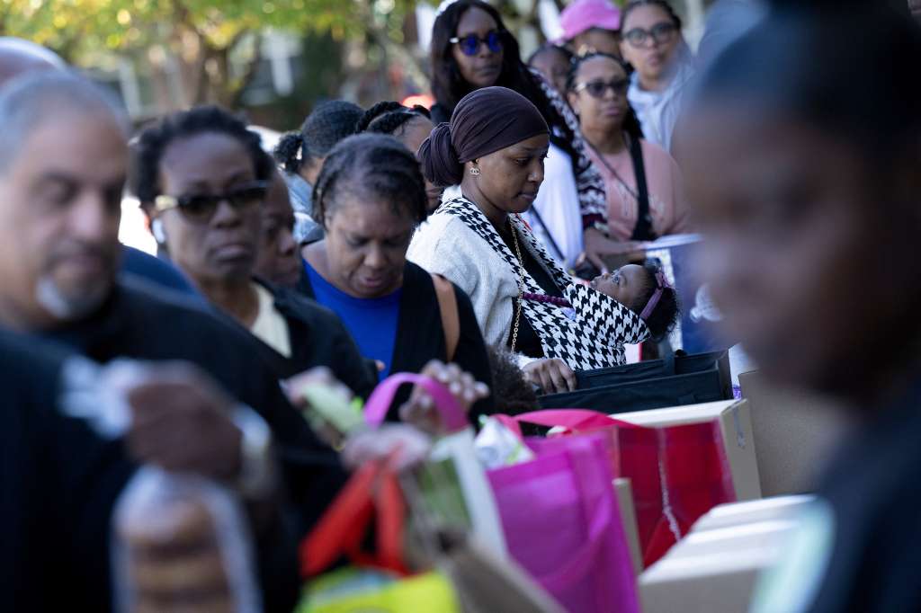 Personas hacen fila para recibir alimentos para empleados federales en licencia en No Limits Outreach Ministries el 21 de octubre de 2025 en Hyattsville, Maryland.