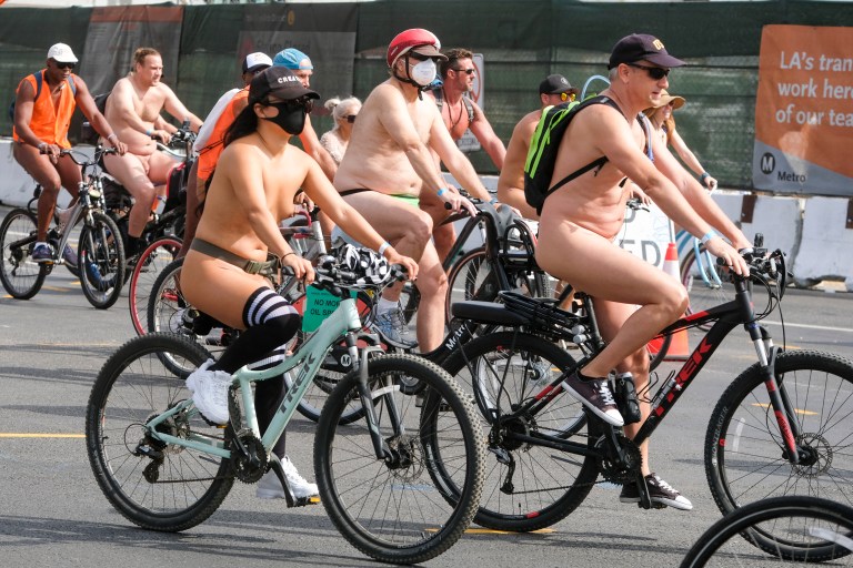 EDITORS NOTE: Graphic content / Nude cyclists get ready for the World Naked Bike Ride on September 18, 2021 in downtown Los Angeles. (Photo by RINGO CHIU / AFP)