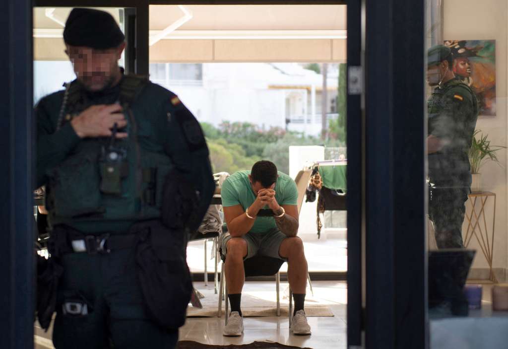 TOPSHOT - Members of Spanish Guardia Civil, supported by Europol, arrest a man during an operation against drug trafficking in Mijas, near Malaga, on June 12, 2024.