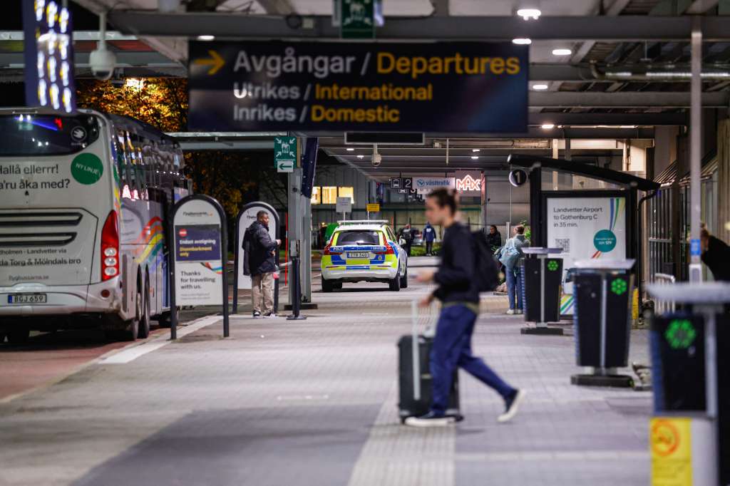 A police vehicle is seen in front of an entrance of Landvetter Airport as the airport was temporarily closed in evening on November 6, 2025 in Gothenburg, Sweden, after drones were observed around the airport.