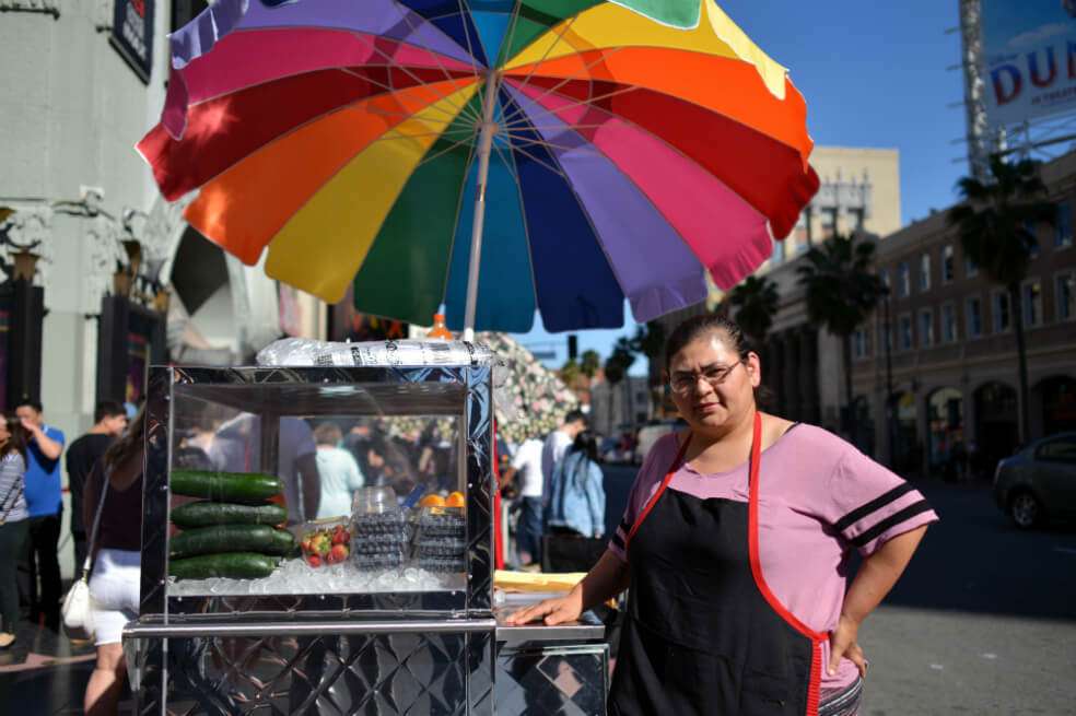 En algunos sectores de Los Ángeles, los vendedores ambulantes pagan entre 1.000 y 5.000 dólares mensualmente a los dueños de los comercios formales para instalarse al frente de sus tiendas a vender. / AFP