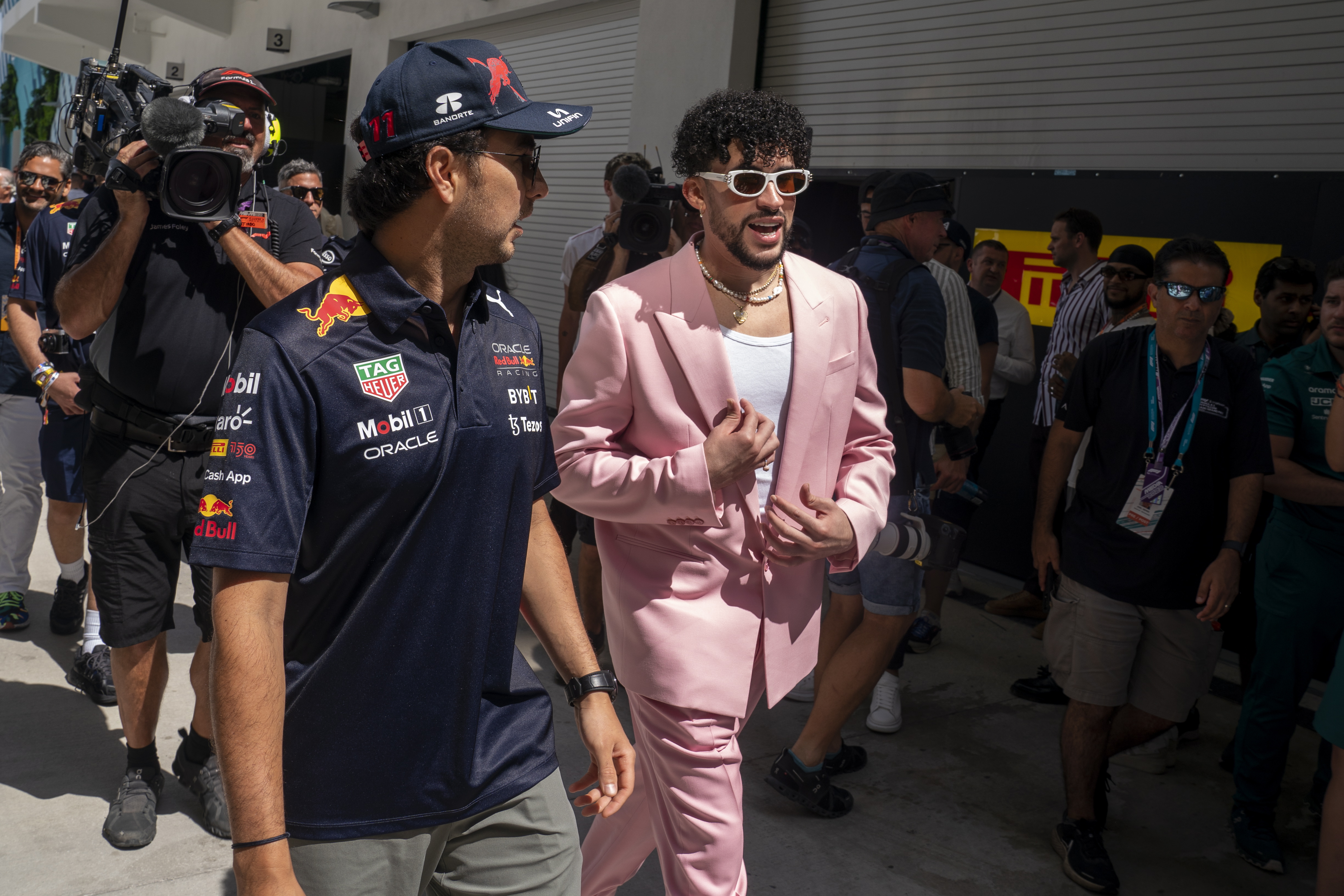 Miami Gardens (United States), 08/05/2022.- Mexican Formula One driver Sergio Perez (L) of Red Bull Racing and Puerto Rican rapper Bad Bunny walk in the Paddock prior to the Formula One Grand Prix of Miami at the Miami International Autodrome in Miami Gardens, Florida, USA, 08 May 2022. (Fórmula Uno, Estados Unidos, Roma) EFE/EPA/SHAWN THEW