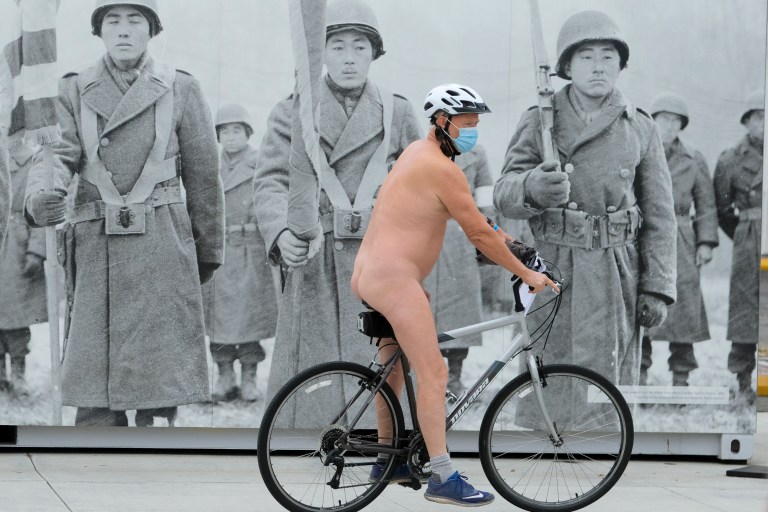 EDITORS NOTE: Graphic content / Nude cyclists get ready for the World Naked Bike Ride on September 18, 2021 in downtown Los Angeles. (Photo by RINGO CHIU / AFP)