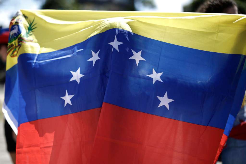 AME2134. SAN JOSÉ (COSTA RICA), 04/01/2026.- Una persona sostiene una bandera de Venezuela durante una manifestación tras la captura del presidente de Venezuela, Nicolás Maduro, este domingo, en la Plaza de la Democracia en San José (Costa Rica). EFE/ Jeffrey Arguedas