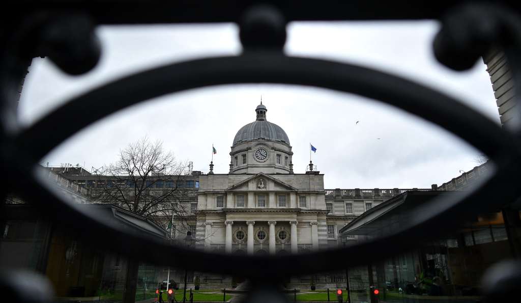 (FILES) The national flag of Ireland (L) and the European Union (EU) flag fly atop Government Buildings in Dublin on February 7, 2020, on the eve of the country's General Election.
