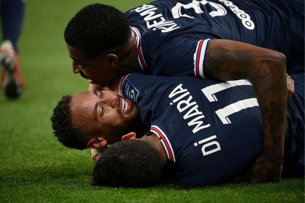 Paris Saint-Germain's Argentinian midfielder Angel Di Maria celebrates with Paris Saint-Germain's Brazilian forward Neymar and Paris Saint-Germain's French defender Presnel Kimpembe after scoring a goal during the French L1 football match between Paris Saint-Germain (PSG) and LOSC Lille at the Parc des Princes stadium, in Paris, on October 29, 2021.
