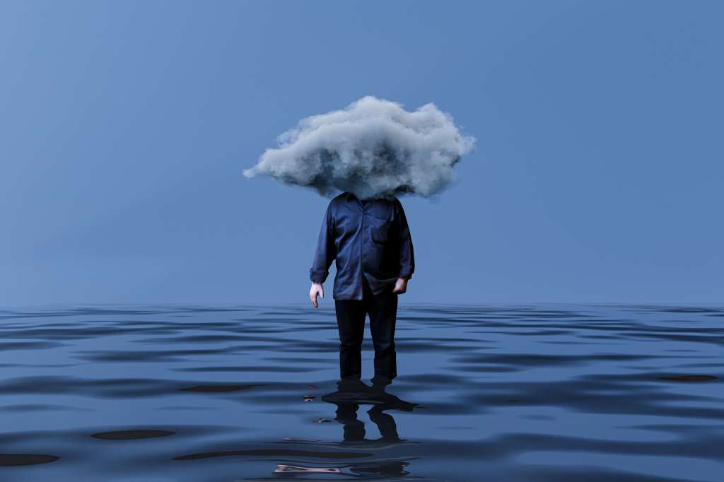 Computer graphic of male figure has fluffy cloud instead of head and standing in rippled water. Man with head in cloud and wet feet.
