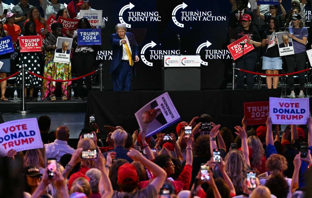 Former US President and 2024 Republican presidential candidate Donald Trump points to people in the crowd at the end of a town hall event at Dream City Church in Phoenix, Arizona, on June 6, 2024. (Photo by Jim WATSON / AFP)