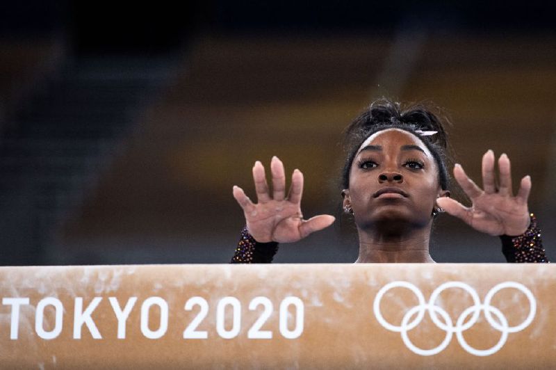 US gymnast Simone Biles prepares to practice on the balance beam during a training session at the Ariake Gymnastics Centre in Tokyo on July 22, 2021, on the eve of the start of the Tokyo 2020 Olympic Games. (Photo by Loic VENANCE / AFP)

