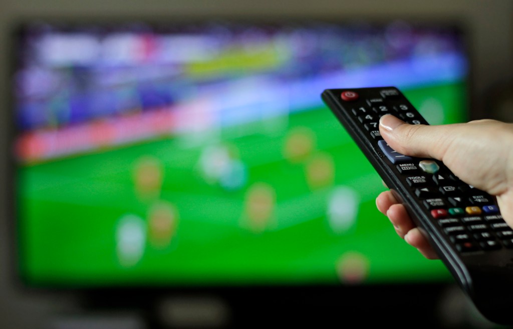 Fmeale tuning into soccer on TV