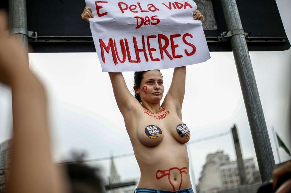 A demonstrator takes part in a protest against Brazilian right-wing presidential candidate Jair Bolsonaro, called by a social media campaign under the hashtag #EleNao (Not Him), at Largo da Batata in Sao Paulo, Brazil on September 29, 2018. Women across Brazil launched a wave of nationwide protests on Saturday against the candidacy of the right-wing frontrunner in next week's presidential elections, Jair Bolsonaro who has been branded racist, misogynist and homophobic. / AFP / Miguel SCHINCARIOL