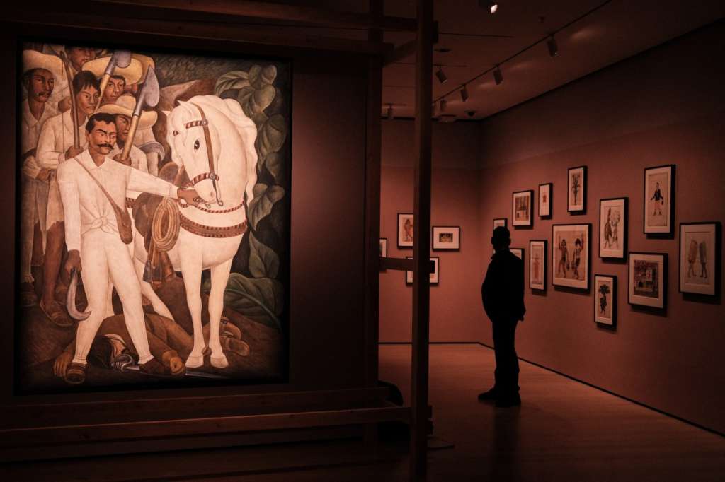The painting "Agrarian Leader Zapata" by Diego Rivera is displayed as a man views artworks during a press preview of the exhibition "Frida and Diego: The Last Dream" at the Museum of Modern Art (MoMA) in New York City on March 16, 2026.